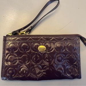 Coach Patent Purple Wristlet Wallet with Embossed Monogram.